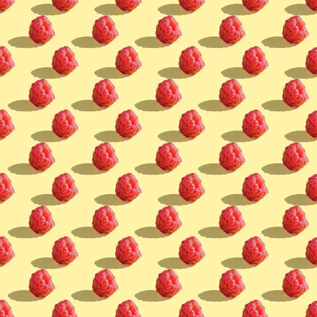 Raspberries seamless pattern on light yellow background