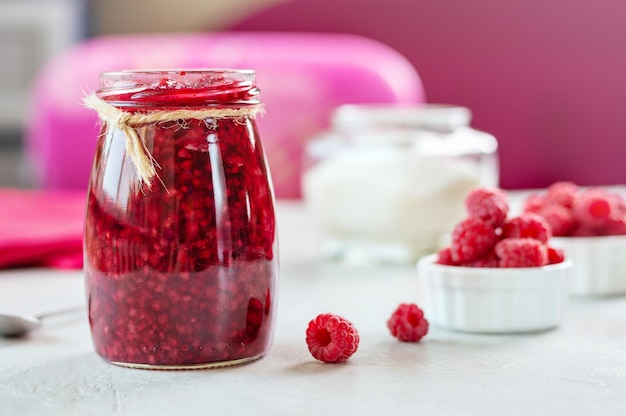 Raspberries with sugar Homemade jam with fresh berry on the table selective focus