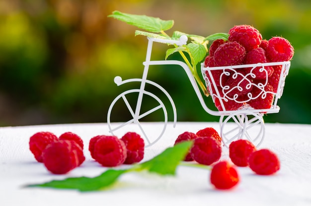 Raspberry berries on a white wooden background.