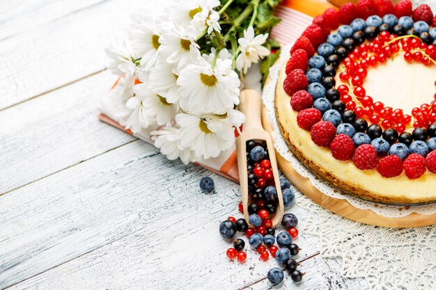 Raspberry and blueberry cheesecake on wooden table