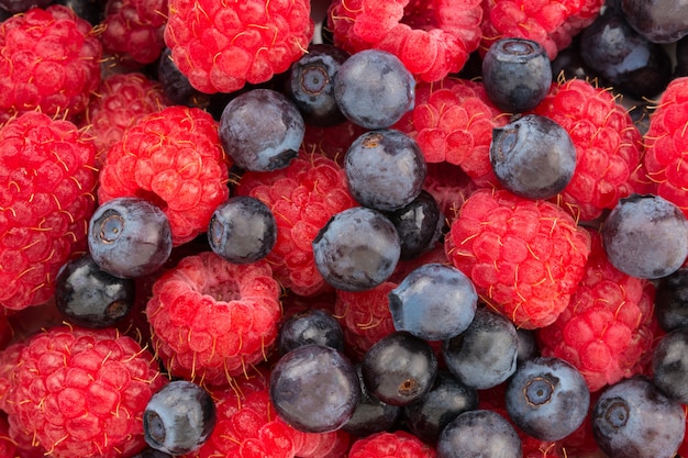 Raspberry and blueberry. Fresh organic berries macro.