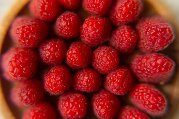 Photo raspberry close-up on a beautiful stand, summer fruit.