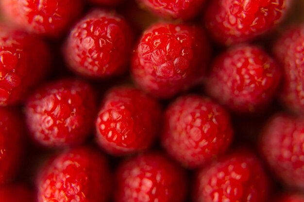 Raspberry close-up on a beautiful stand, summer fruit.