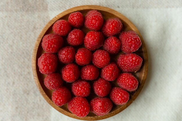 Photo raspberry close-up on a beautiful stand, summer fruit.