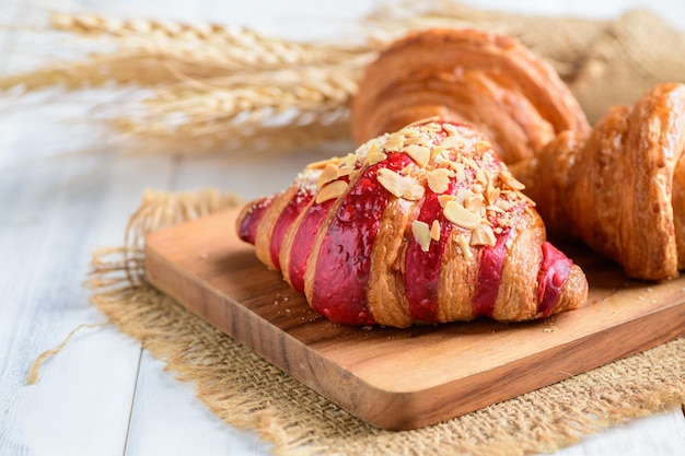 Raspberry Crumble Cream Cheese Croissant on wood plate Home made bakery