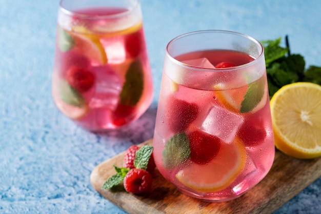 Raspberry lemonade drink on blue background