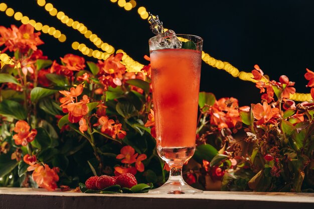 Raspberry lemonade with lavender and ice on flower background