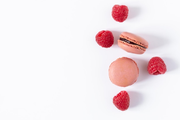 Raspberry macaroons dessert on white background top view French meringue cookie macarons background