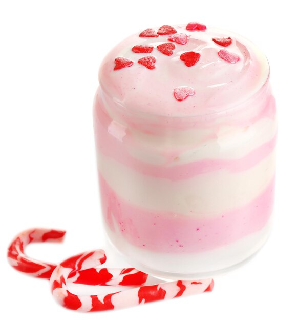 Raspberry milk dessert in glass jar, isolated on white