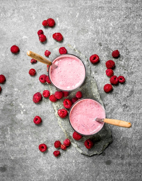 Raspberry milk smoothie. On rustic background