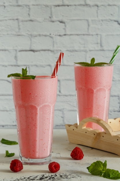 Raspberry milkshake with mint and drinking straws