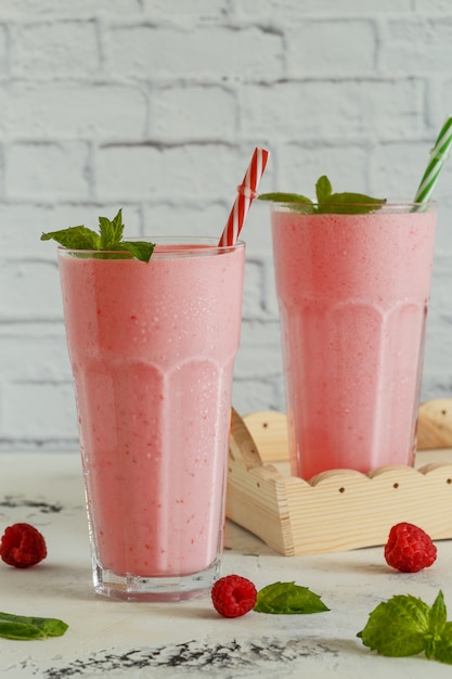 Raspberry milkshake with mint in glasses