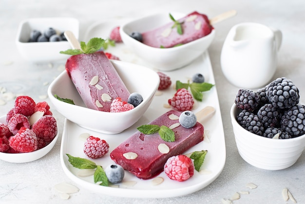 Raspberry and mint popsicles with frozen berries and fresh mint