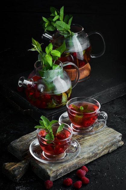 Raspberry and mint tea Hot winter drinks On a black background Top view