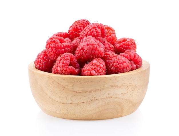 Raspberry in wood bowl  isolated on white background