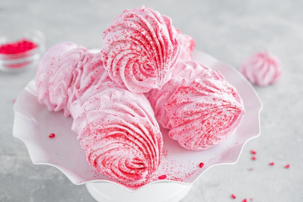 Raspberry zephyr marshmallows on a cake stand Copy space selective focus