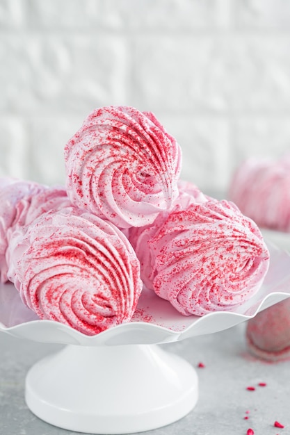 Raspberry zephyr Russian marshmallows on a cake stand Copy space selective focus