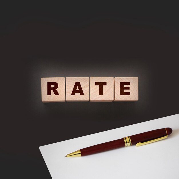 Rate word concept on wooden cubes on black Business services rating concept
