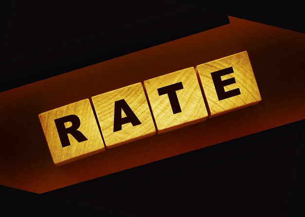 Rate word concept on wooden cubes on black Business services rating concept