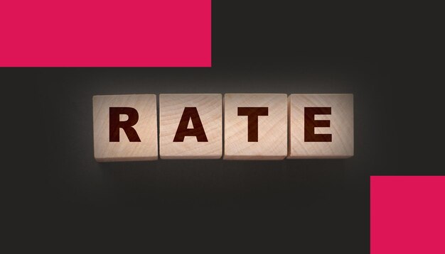 Rate word concept on wooden cubes on black Business services rating concept