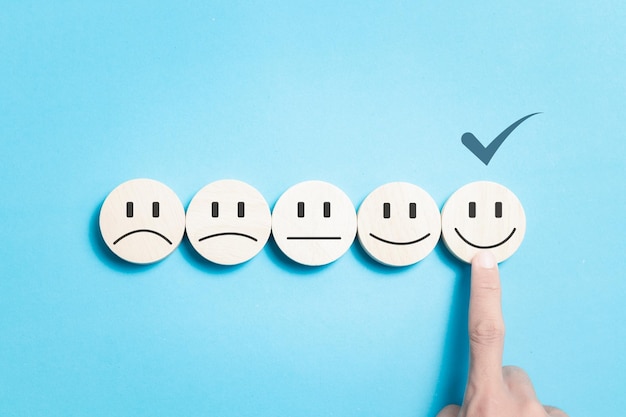 rating satisfaction with smiling face wooden block satisfaction experience rating and service reviews customer satisfaction service concept