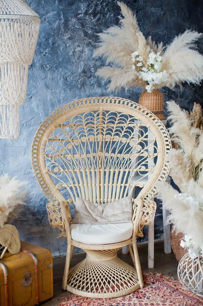 Rattan peacock chair in loft room with boho decorations