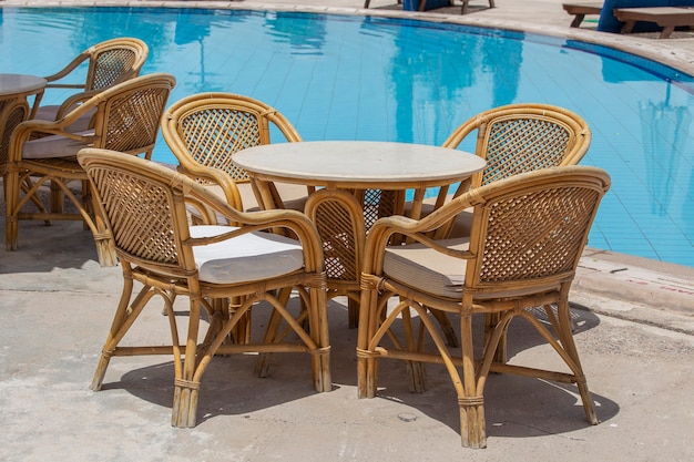 Rattan table and chairs in beach cafe near swimming pool in Egypt