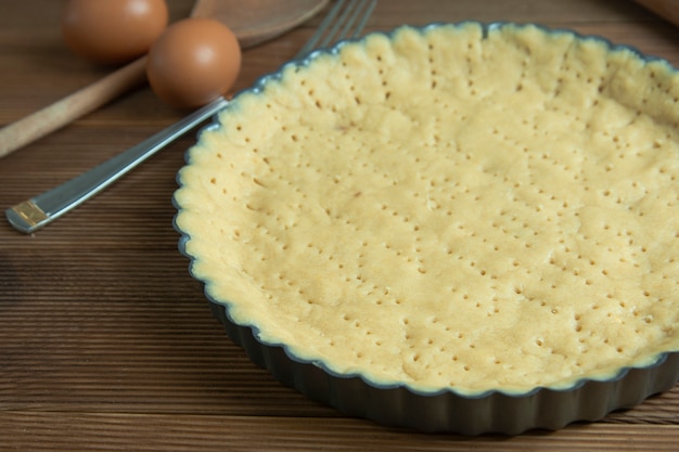 Rauw taartdeeg, basisgebak voor taart, taart of cake. Gezond dessert koken in de pan bakken.