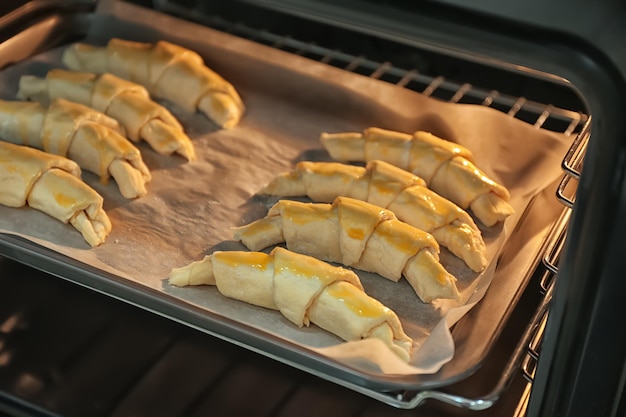 Rauwe croissants op bakplaat in de oven