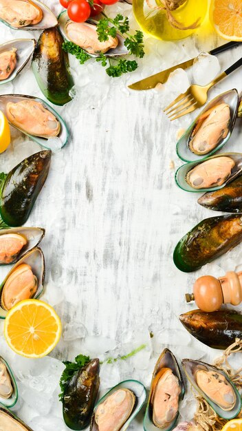 Rauwe groene grote mosselen met kruiden op ijs De kokkels zijn klaar voor het diner Vrije ruimte voor tekst