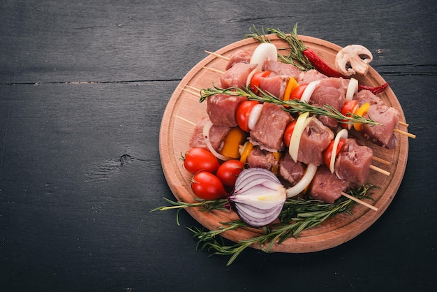 Rauwe kebab van vlees op een houten ondergrond met groenten Bovenaanzicht Vrije ruimte voor tekst