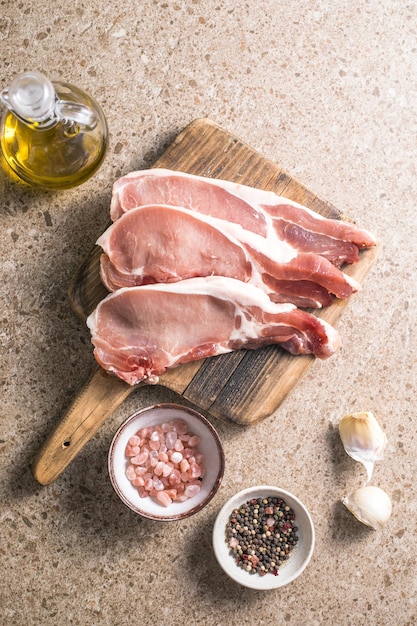 Rauwe varkenssteaks met specerijen kruiden op snijplank Vers vlees Bovenaanzicht kopieerruimte