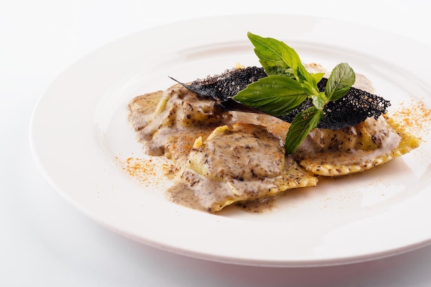 Ravioli in creamy truffle sauce on plate