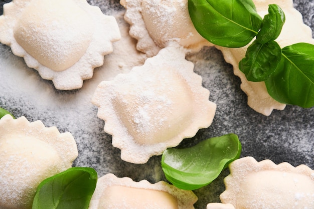 Ravioli Italian food Tasty homemade with flour tomatoes eggs and greens basil on dark background Food cooking ingredients background Top view