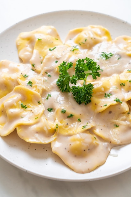 ravioli pasta with mushroom cream sauce and cheese - Italian food style