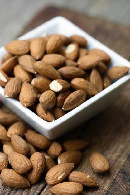 Raw almond on wooden board