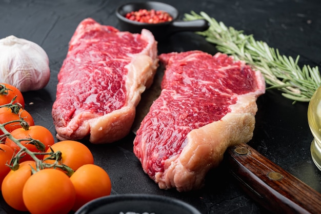 Raw ambassador beef steak cut, on black table