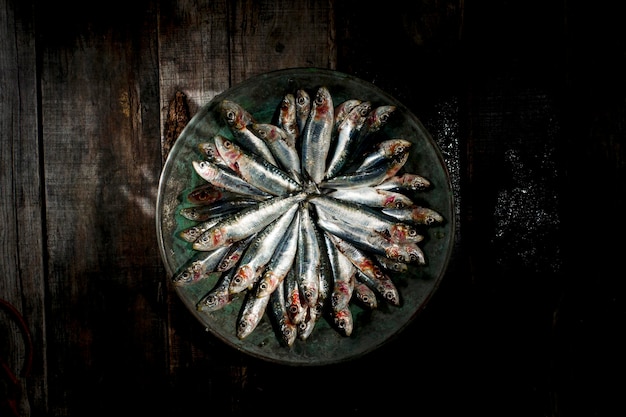 Raw anchovies in dish