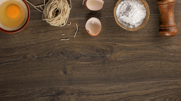 Raw Asian Homemade Noodle with Eggs, Salt, Egg Shell, and Flour, Copy Space for Wallpaper or Backgrounds