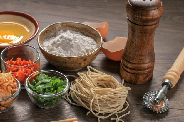 Raw Asian Homemade Noodle with Eggs, Salt, Egg Shell, and Flour, Copy Space for Wallpaper or Backgrounds