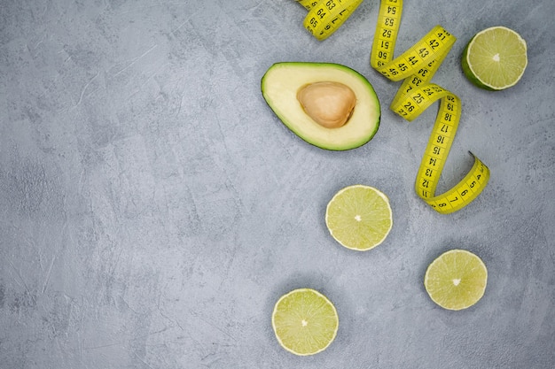 Raw avocado half with tape measure