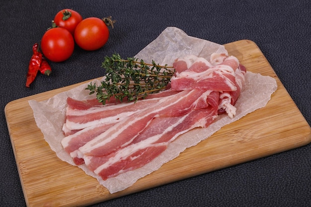 Raw bacon on the board