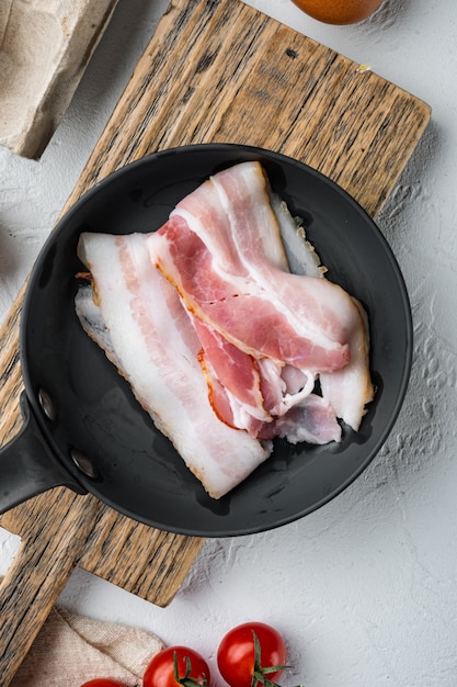 Raw bacon set, on white background, top view flat lay