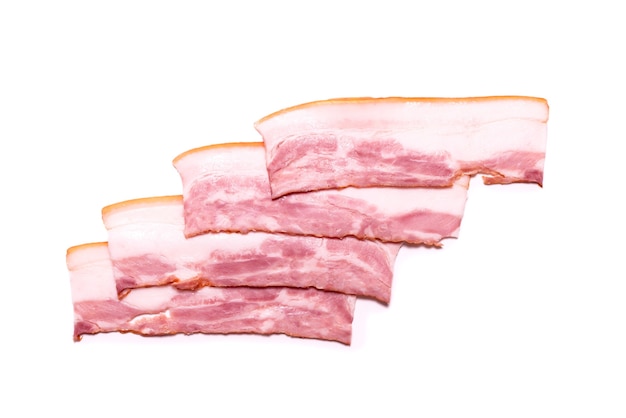 Raw bacon slices isolated on a white surface. Top view.