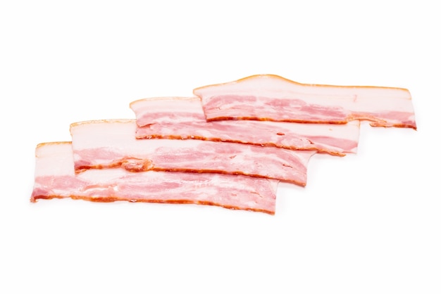 Raw bacon slices isolated on a white surface