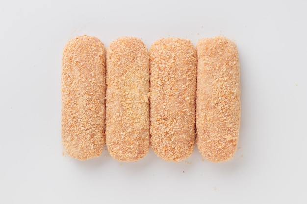 Raw beached meat cutlets isolated on a white background