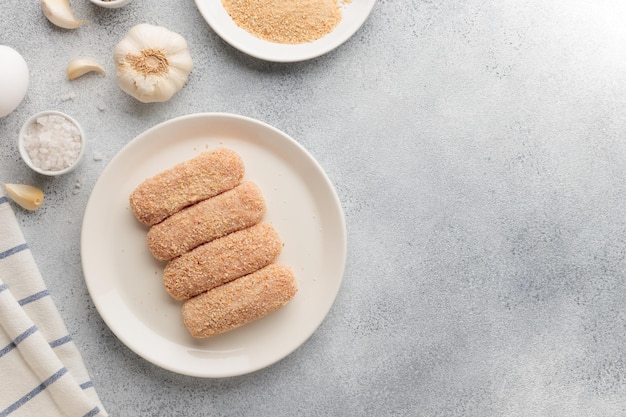 Raw beached meat cutlets on a plate