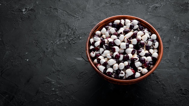 Raw beans in a bowl. Top view. Free copy space.