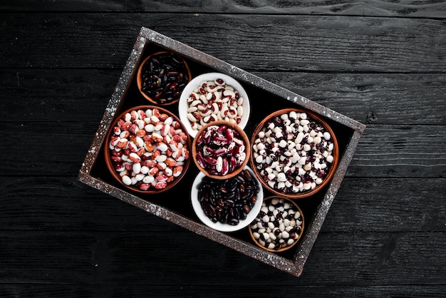 Raw beans in a wooden box. Top view. Free copy space.