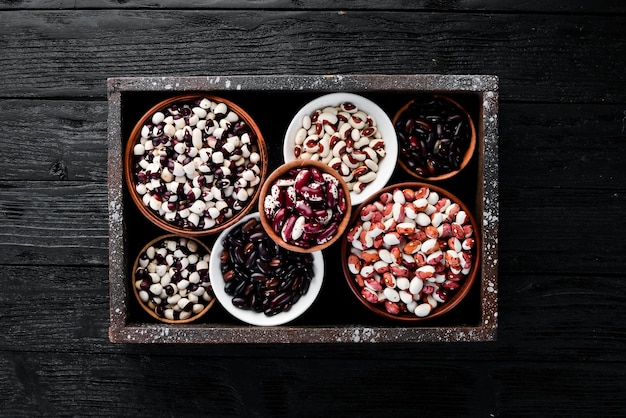 Raw beans in a wooden box Top view Free copy space